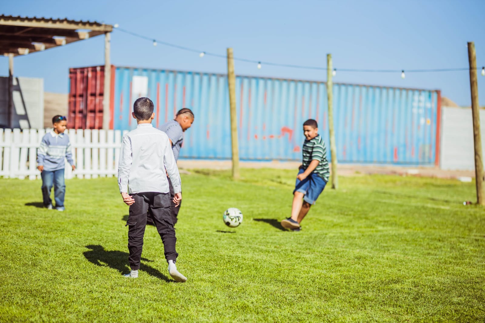 Children playing football on the open lawn at Mini & Me